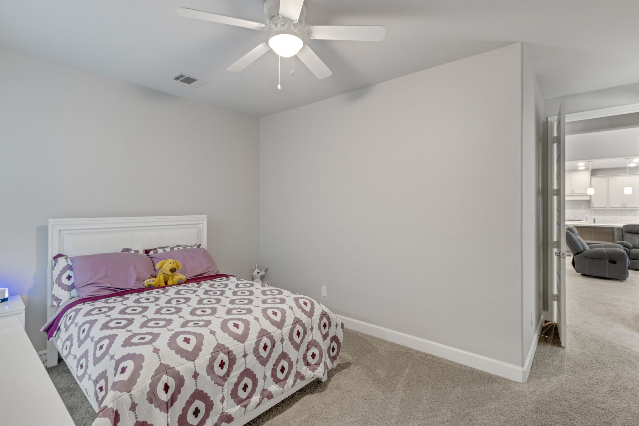 17467 Bayflower Conroe, TX 77385 - Photo 24 of 44 a bedroom with a bed and a chandelier