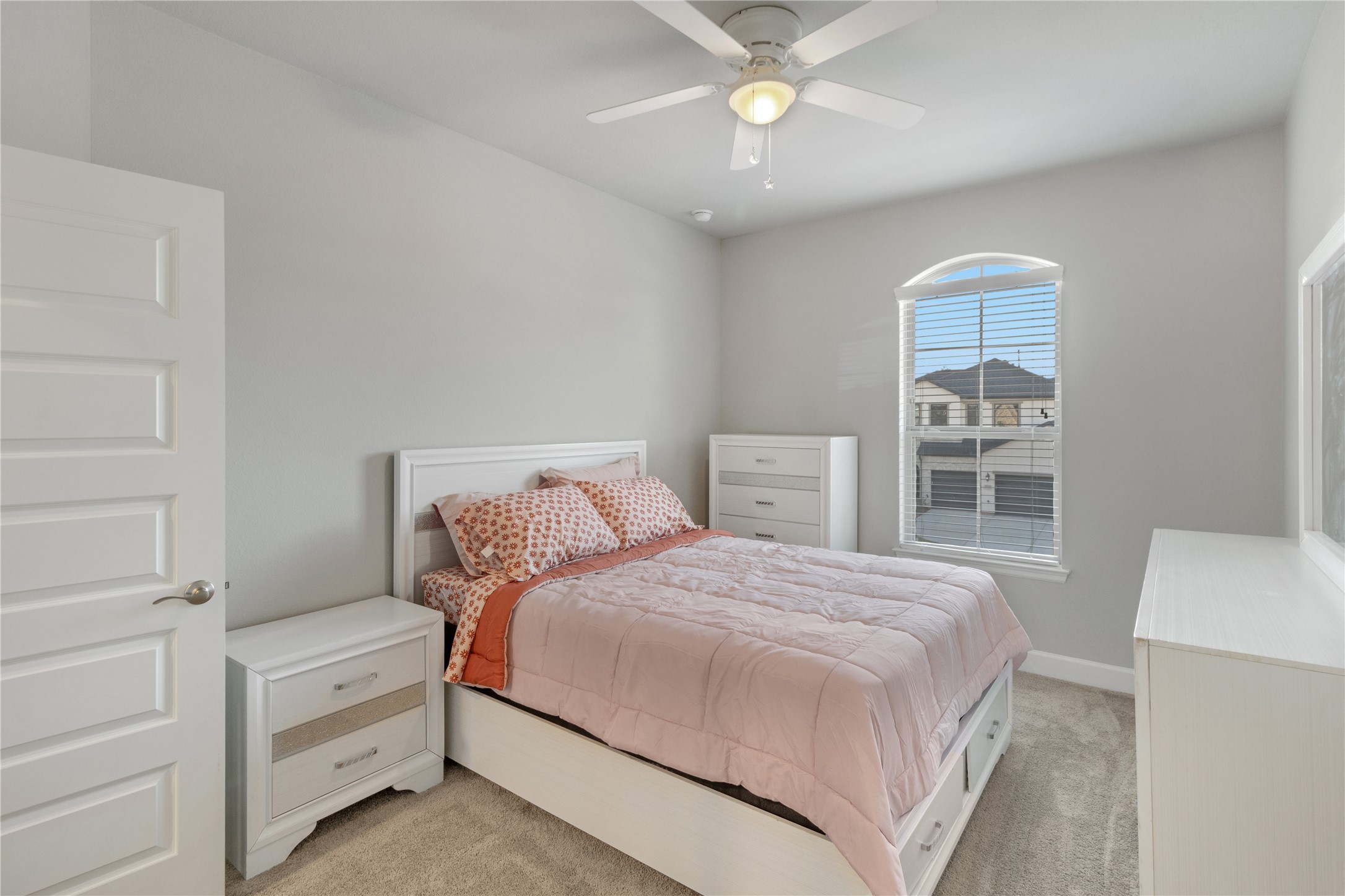 17467 Bayflower Conroe, TX 77385 - Photo 29 of 44 a bedroom with a large bed and a chandelier