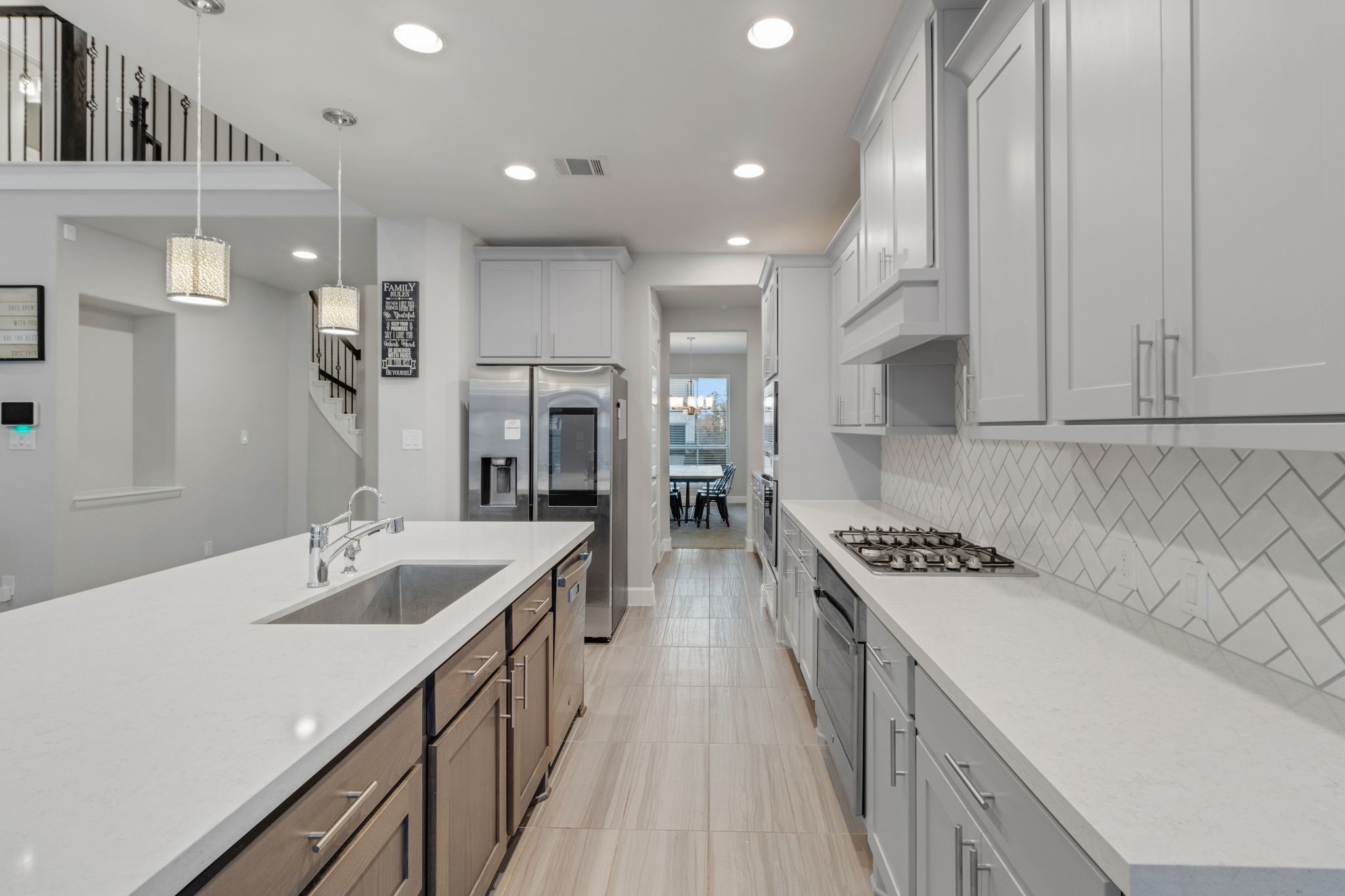 17467 Bayflower Conroe, TX 77385 - Photo 10 of 44 a kitchen with stainless steel appliances granite countertop a sink stove and refrigerator