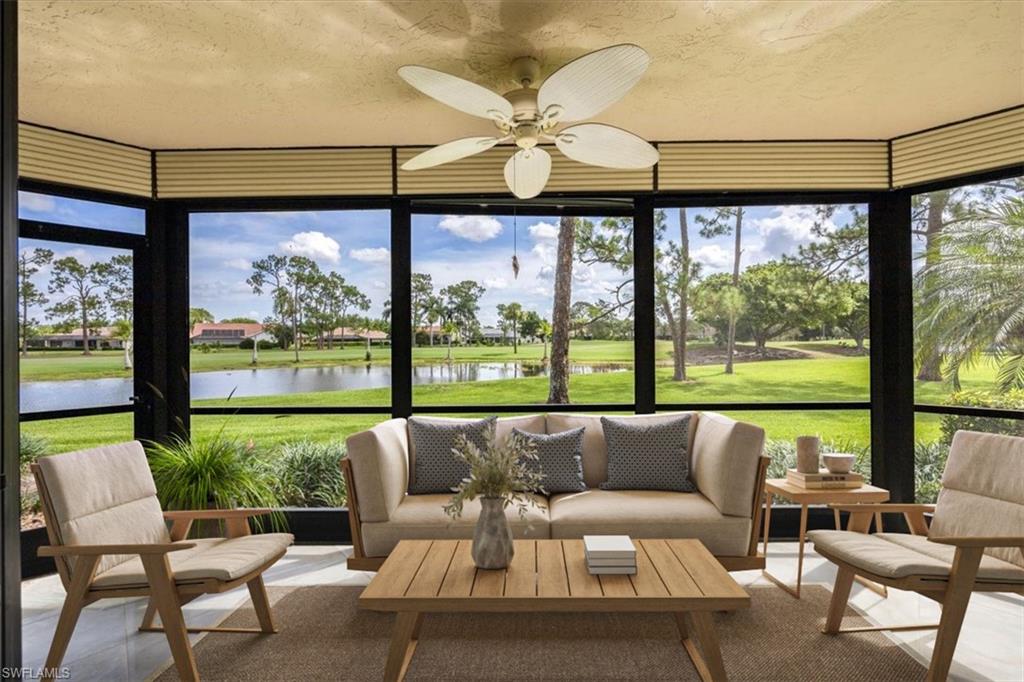 415 Augusta Boulevard, Unit 110 Naples, FL 34113 - Photo 1 of 31 a living room with furniture and a floor to ceiling window