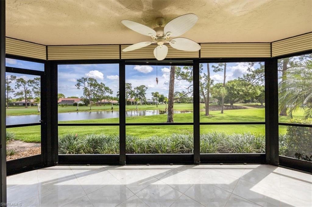 415 Augusta Boulevard, Unit 110 Naples, FL 34113 - Photo 11 of 31 a view of a porch with a floor to ceiling window wooden floor and a table in the room