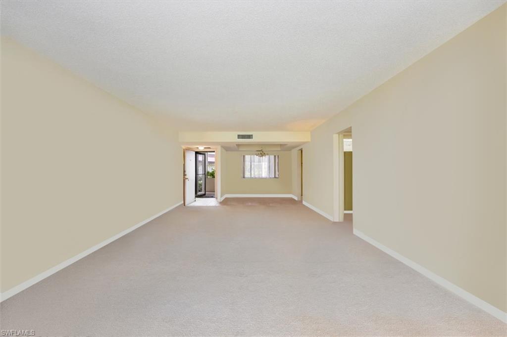 415 Augusta Boulevard, Unit 110 Naples, FL 34113 - Photo 13 of 31 a view of an empty room with a window