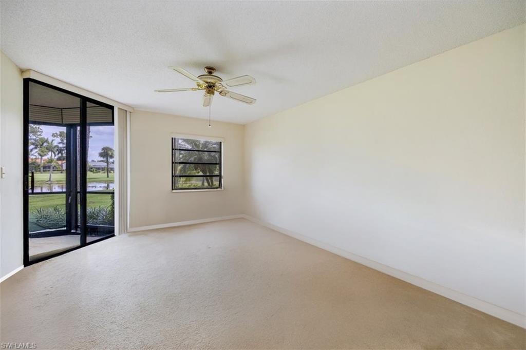 415 Augusta Boulevard, Unit 110 Naples, FL 34113 - Photo 15 of 31 an empty room with windows and ceiling fan
