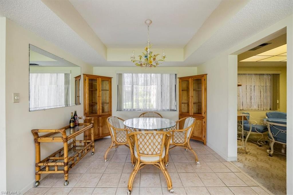 415 Augusta Boulevard, Unit 110 Naples, FL 34113 - Photo 18 of 31 a dining room with furniture and window