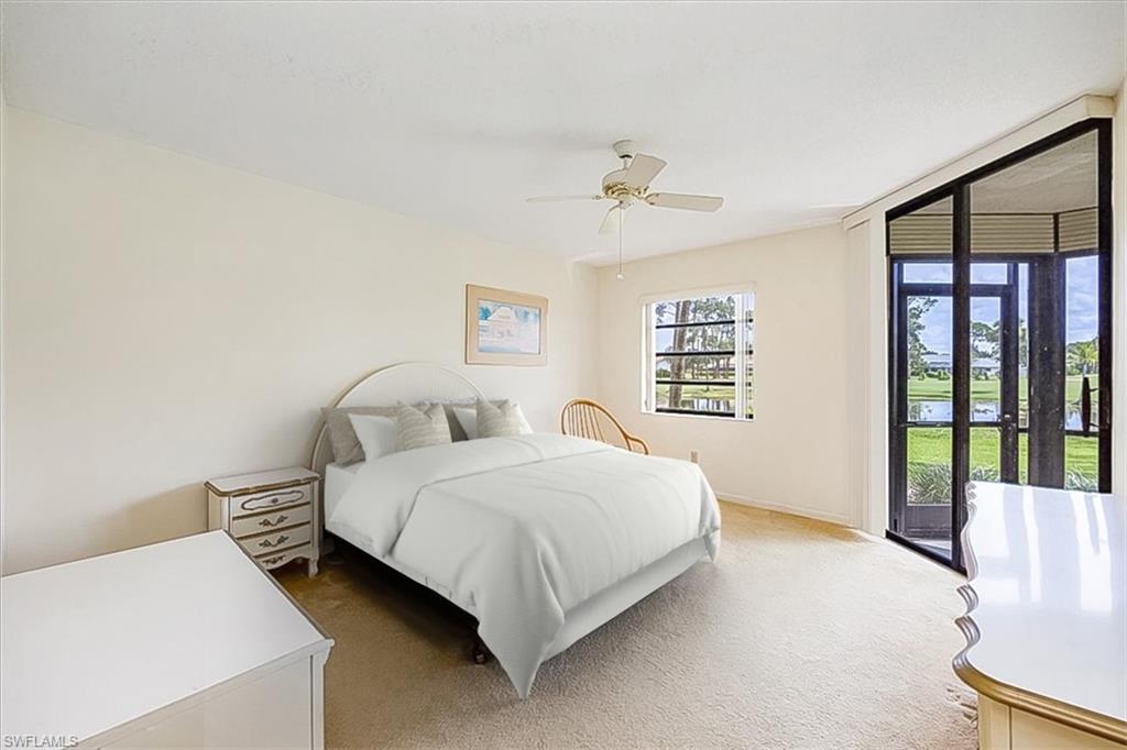 415 Augusta Boulevard, Unit 110 Naples, FL 34113 - Photo 20 of 31 a bedroom with a bed and a large window