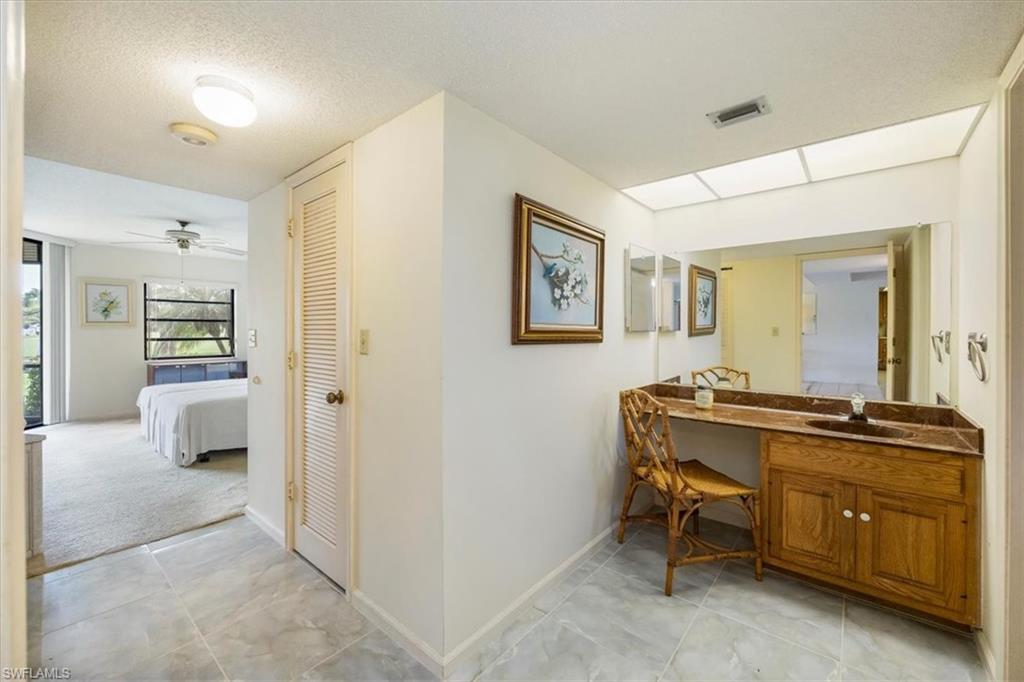 415 Augusta Boulevard, Unit 110 Naples, FL 34113 - Photo 24 of 31 a view of a hallway with workspace and a window