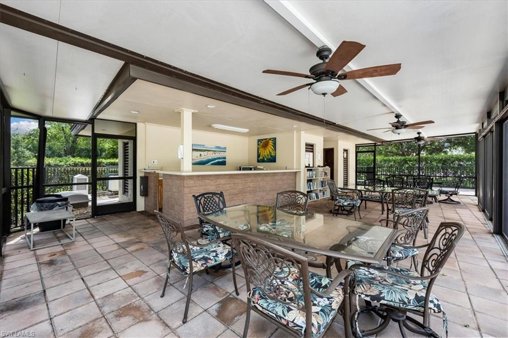 415 Augusta Boulevard, Unit 110 Naples, FL 34113 - Photo 30 of 31 a dining room with furniture and a floor to ceiling window