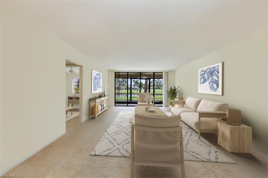 415 Augusta Boulevard, Unit 110 Naples, FL 34113 - Photo 3 of 31 a living room with furniture and a large window