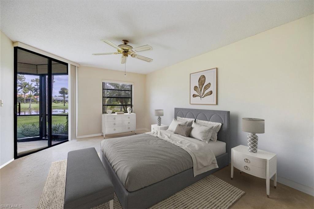 415 Augusta Boulevard, Unit 110 Naples, FL 34113 - Photo 5 of 31 a bedroom with a large bed and a chandelier