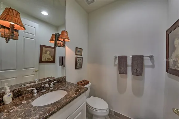 a bedroom with a bed and a lamp on the dresser