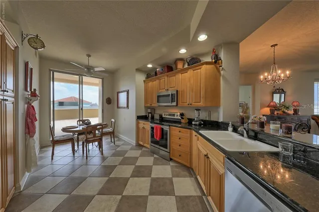 a kitchen with stainless steel appliances kitchen island granite countertop a refrigerator and a stove