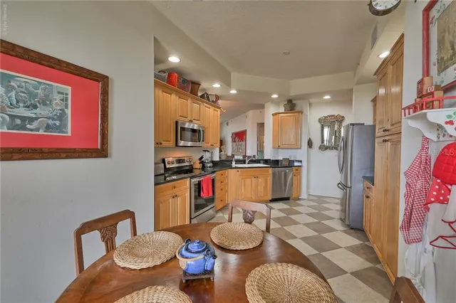 a kitchen with stainless steel appliances granite countertop a refrigerator a sink a stove a microwave oven with granite countertops and cabinets