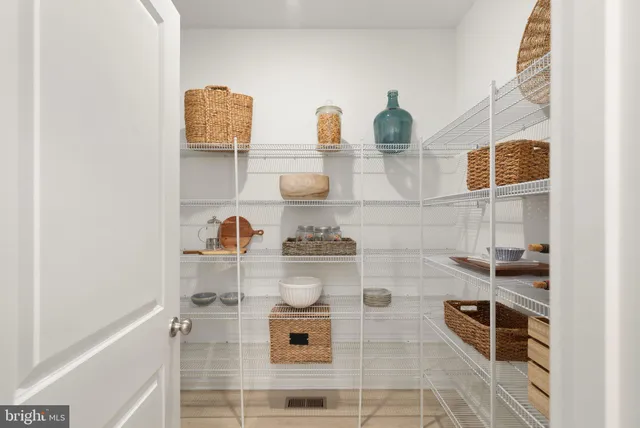 a large kitchen with kitchen island a sink a counter space and stainless steel appliances