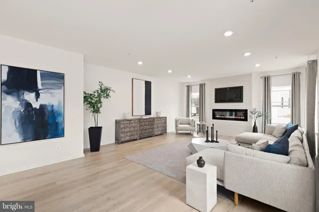 a view of a a dining room with furniture window and wooden floor