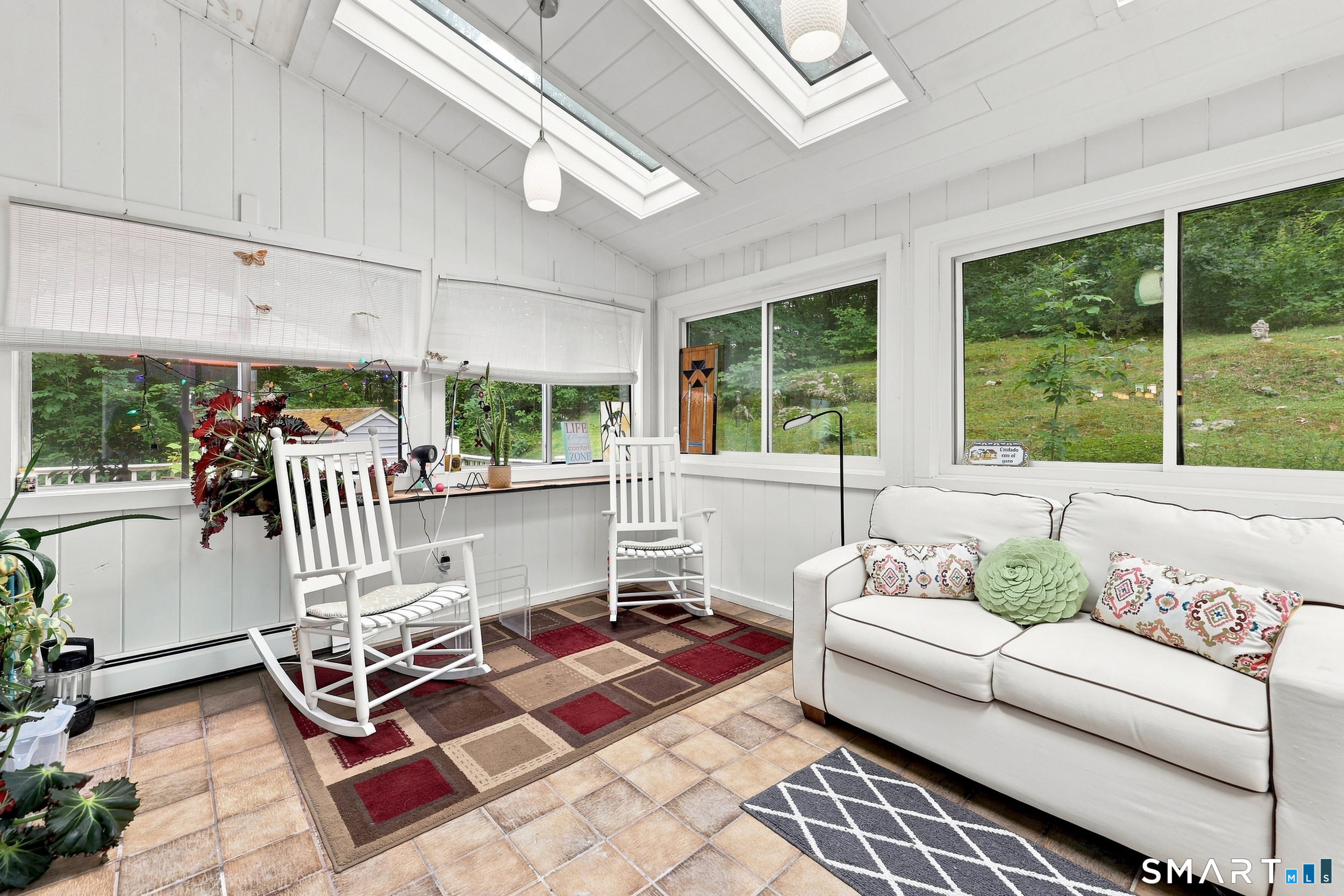 2004 Boston Post Road Guilford, CT 06437 - Photo 10 of 40 Light-filled sunroom with tile floor, skylights, shiplap ceiling and walls. Slider opens to the patio and backyard.