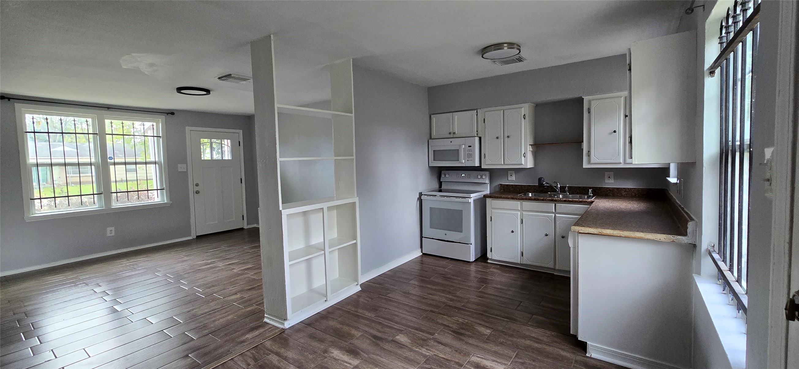 9410 Rosehaven Drive Houston, TX 77051 - Photo 2 of 8 a kitchen with white cabinets and wooden floor