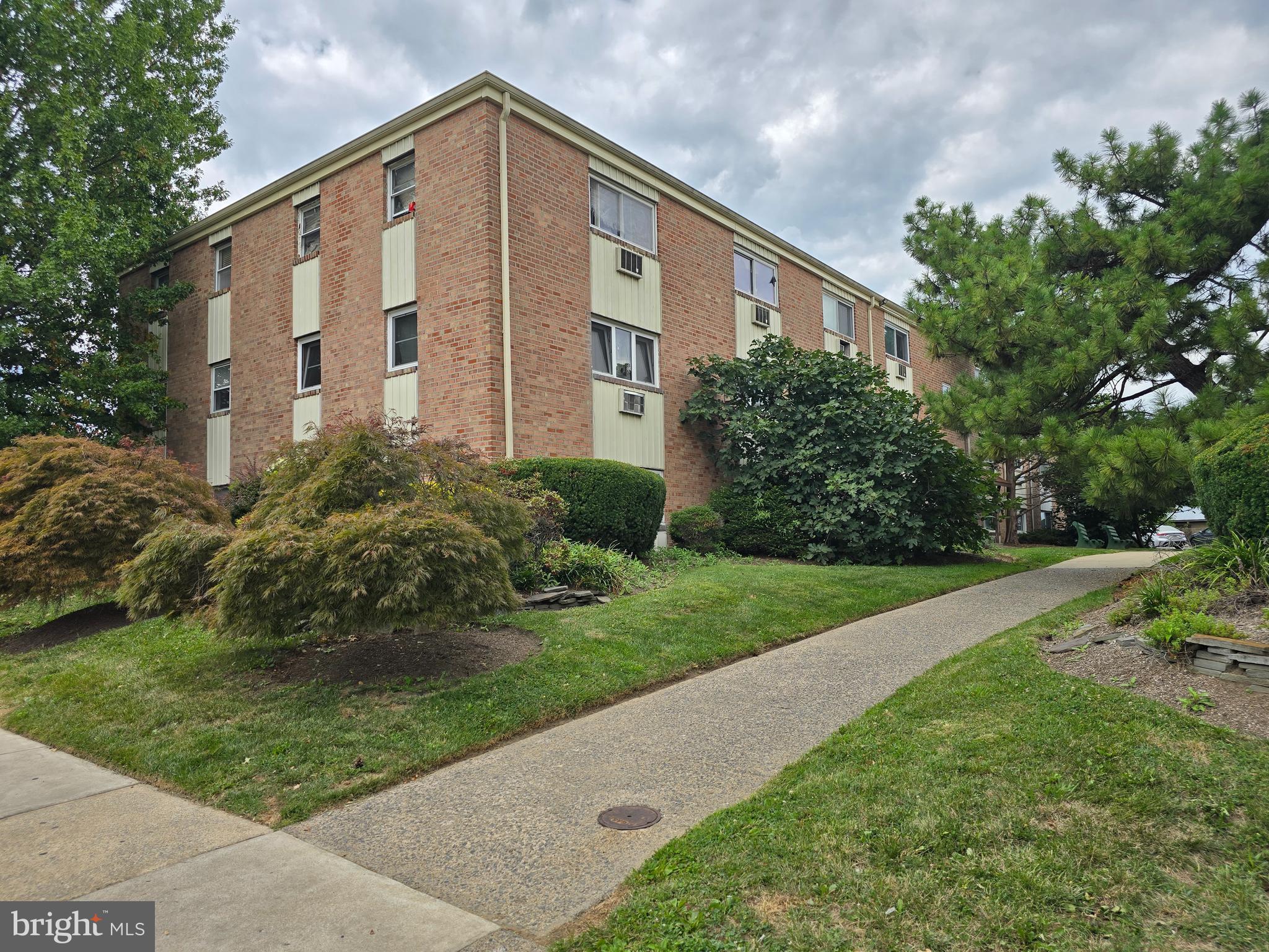 8125 West Chester Pike, Unit A4 Upper Darby, PA 19082 - Photo 2 of 14 a front view of a house with garden