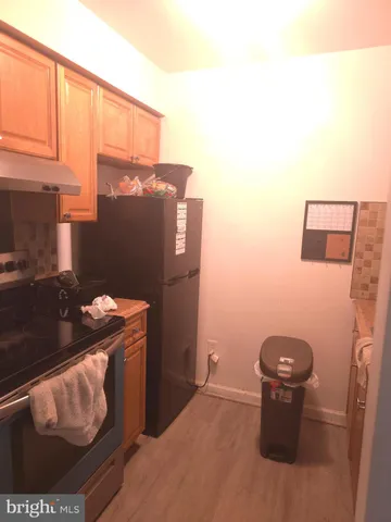 a kitchen with a refrigerator and a stove