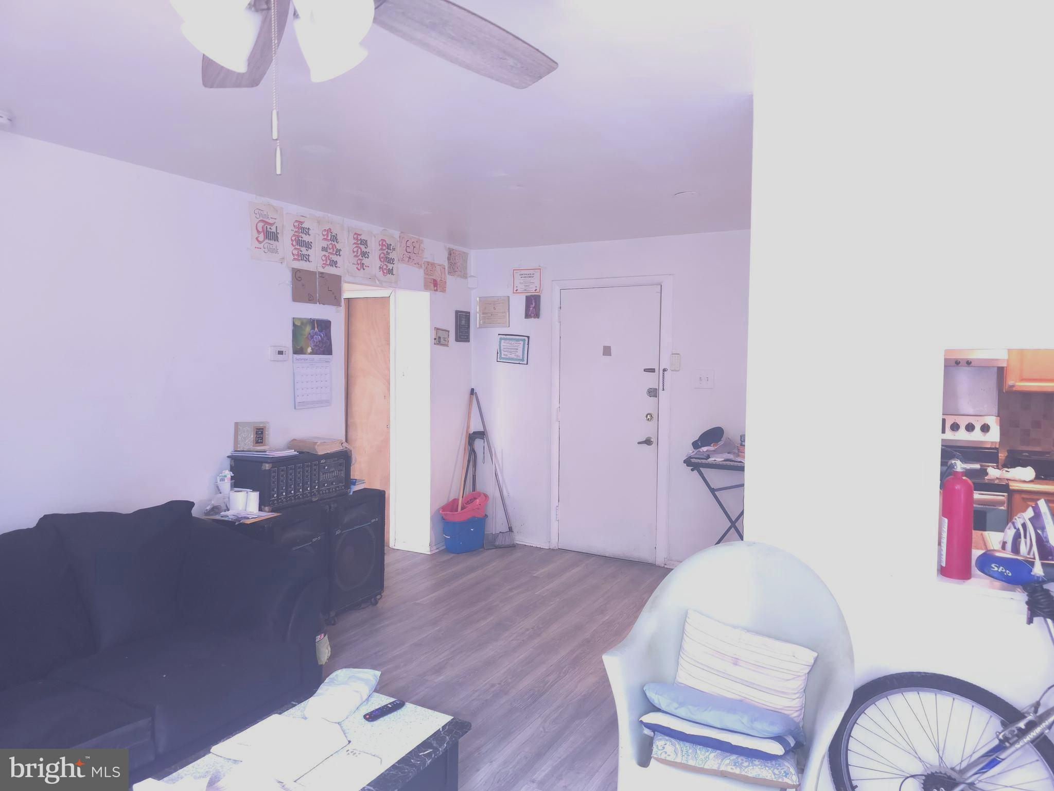 8125 West Chester Pike, Unit A4 Upper Darby, PA 19082 - Photo 10 of 14 a living room with furniture and wooden floor