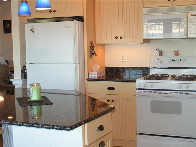 132 Bay Shore Road Hyannis, MA 02601 - Photo 9 of 34 a kitchen with stainless steel appliances granite countertop a sink stove and cabinets