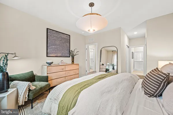 a bedroom with bed and a chandelier
