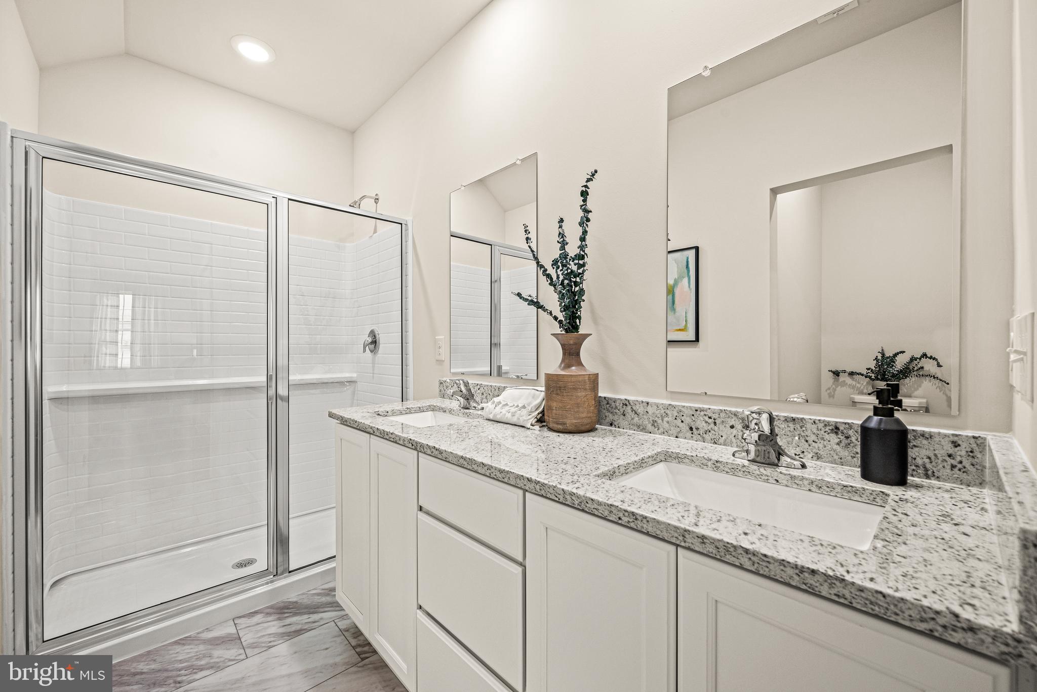 13B Ford Street, Unit A Bridgeport, PA 19405 - Photo 20 of 26 a bathroom with a granite countertop sink and a mirror