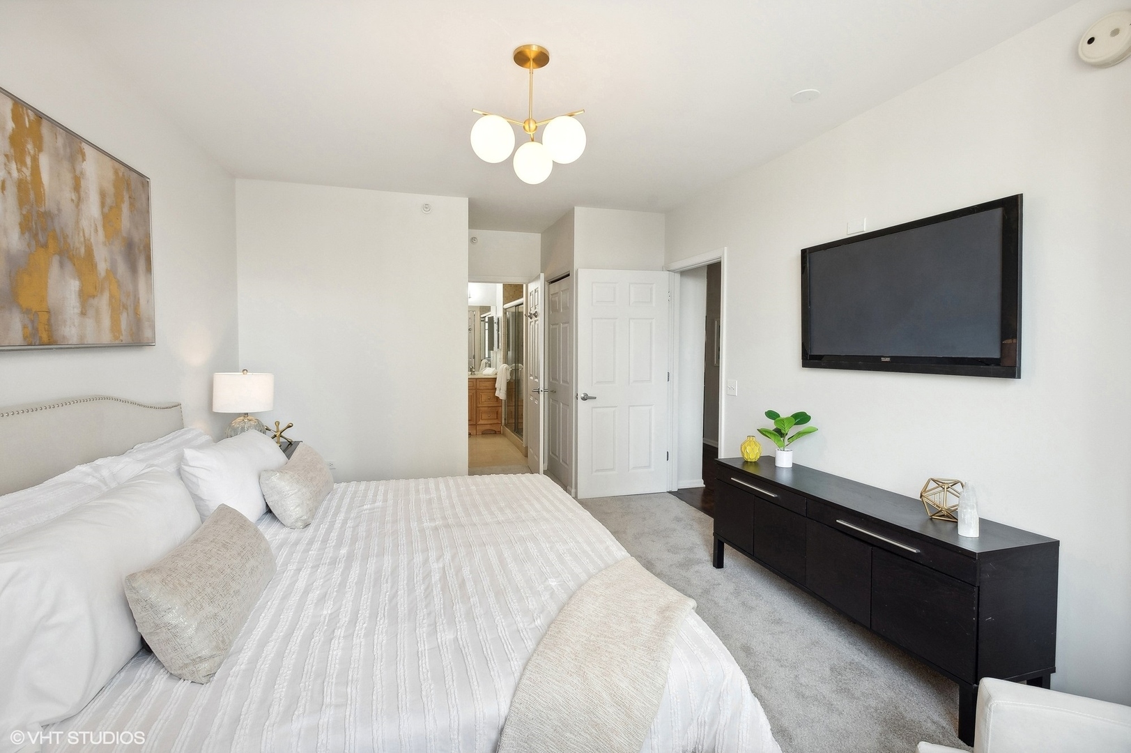 630 North State Street, Unit 1108 Chicago, IL 60654 - Photo 15 of 22 a bedroom with a bed and a flat screen tv