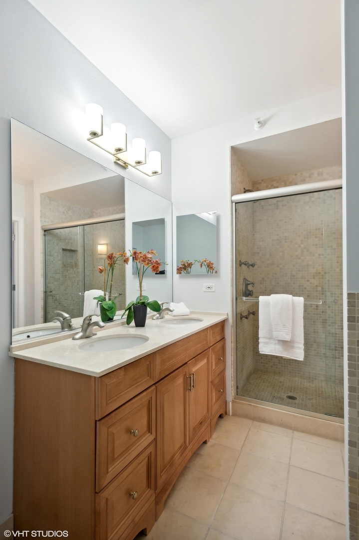 630 North State Street, Unit 1108 Chicago, IL 60654 - Photo 16 of 22 a bathroom with a granite countertop sink mirror and bathtub