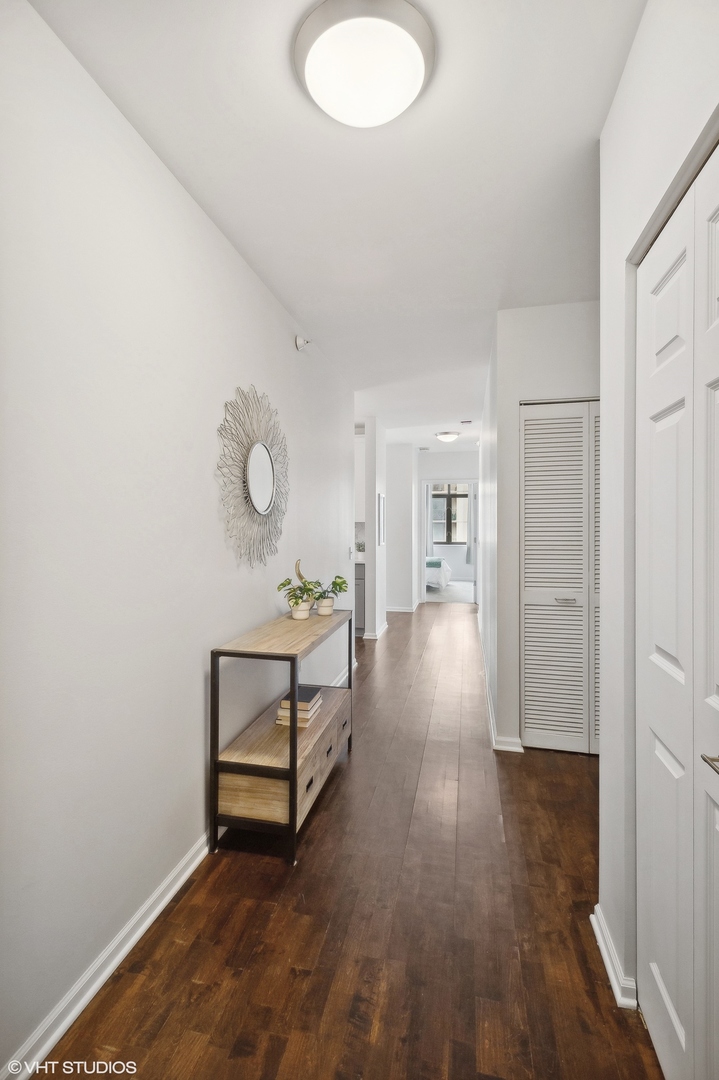 630 North State Street, Unit 1108 Chicago, IL 60654 - Photo 3 of 22 a view of a room with wooden floor and white walls