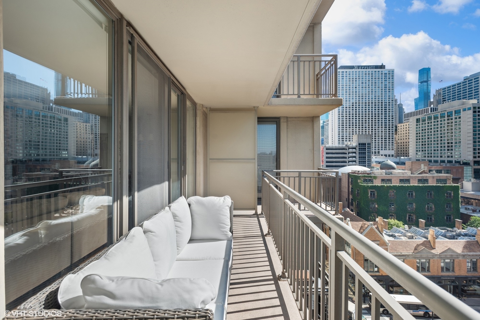 630 North State Street, Unit 1108 Chicago, IL 60654 - Photo 9 of 22 a balcony with furniture and a potted plant
