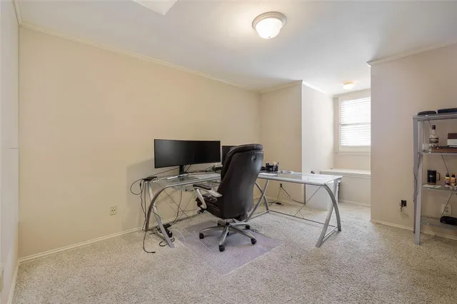 a view of a workspace with furniture and a window
