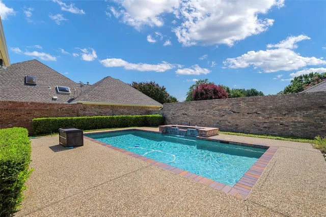 a view of an house with swimming pool and a yard