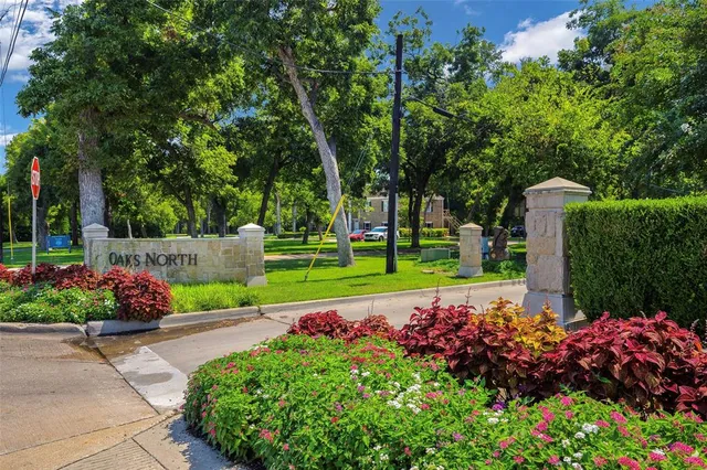 a view of a garden with flowers and trees