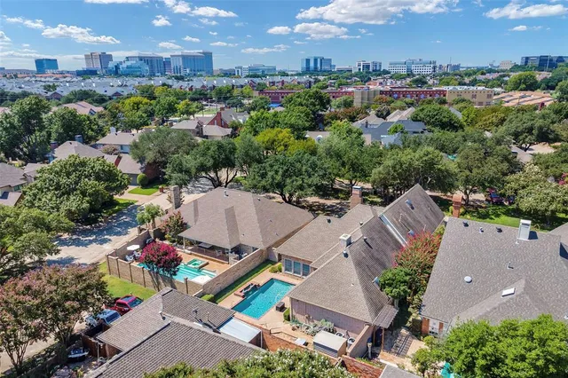 an aerial view of a house with a yard and lake view