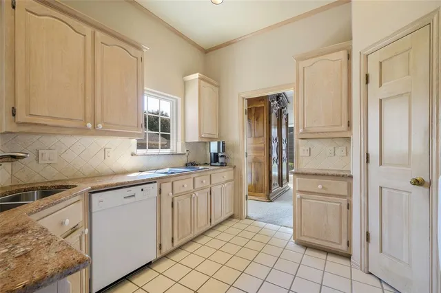 a kitchen with white cabinets and refrigerator