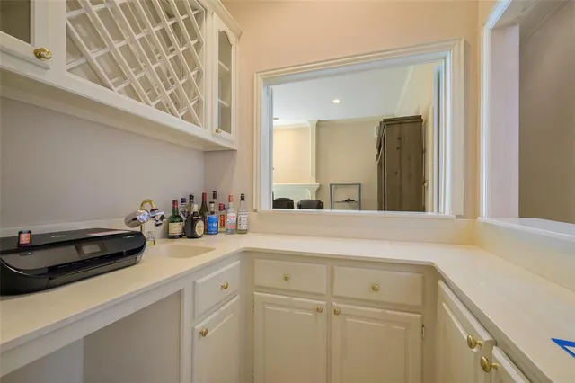 a sink with a cabinets and a stove top oven