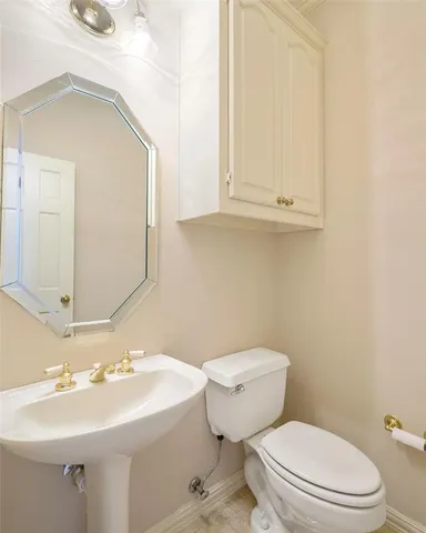 a bathroom with a sink a toilet and mirror