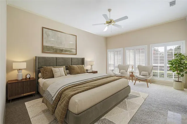 a spacious bedroom with a large bed and a chandelier