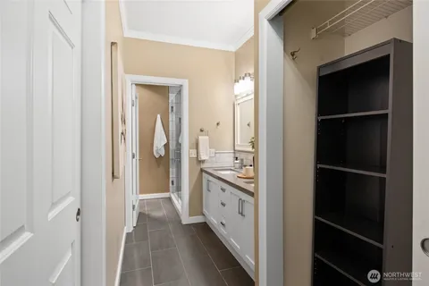 a bathroom with a sink a mirror and a shower