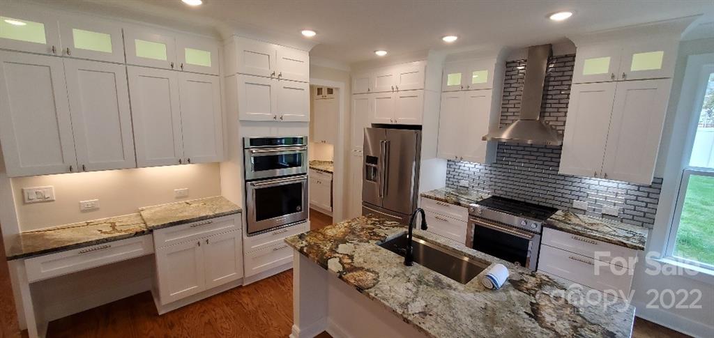 5201 Valley Stream Road Charlotte, NC 28209 - Photo 1 of 17 a kitchen with stainless steel appliances kitchen island granite countertop a stove and a refrigerator