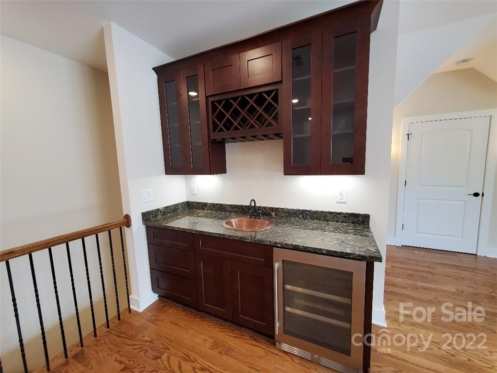 5201 Valley Stream Road Charlotte, NC 28209 - Photo 14 of 17 a bathroom with a granite countertop sink and a mirror
