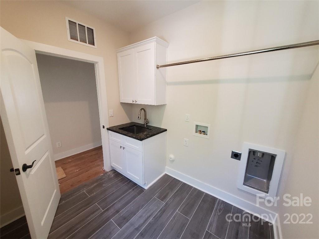 5201 Valley Stream Road Charlotte, NC 28209 - Photo 15 of 17 a kitchen with a refrigerator and a stove top oven