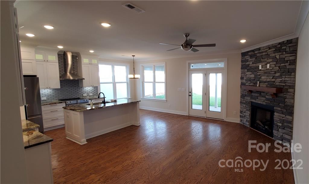 5201 Valley Stream Road Charlotte, NC 28209 - Photo 3 of 17 a kitchen with granite countertop a stove top oven a sink and a counter top space