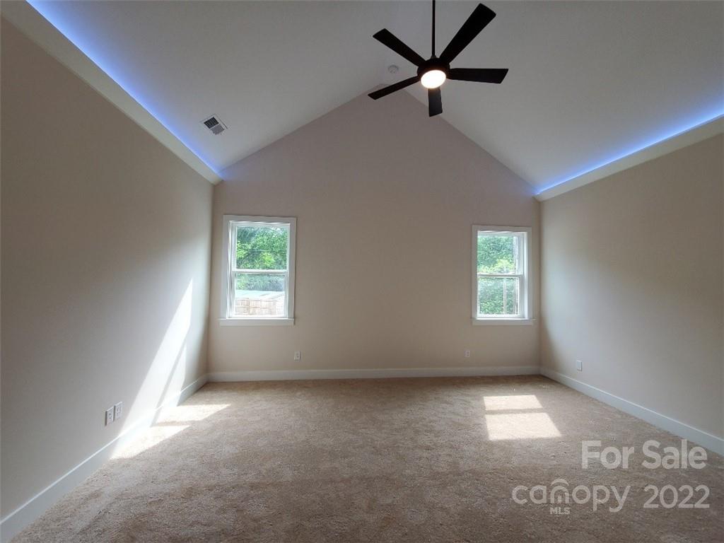 5201 Valley Stream Road Charlotte, NC 28209 - Photo 5 of 17 a view of room with a ceiling fan and window