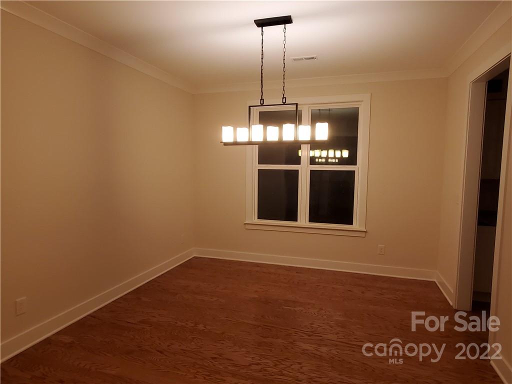 5201 Valley Stream Road Charlotte, NC 28209 - Photo 8 of 17 a view of an empty room with chandelier and window