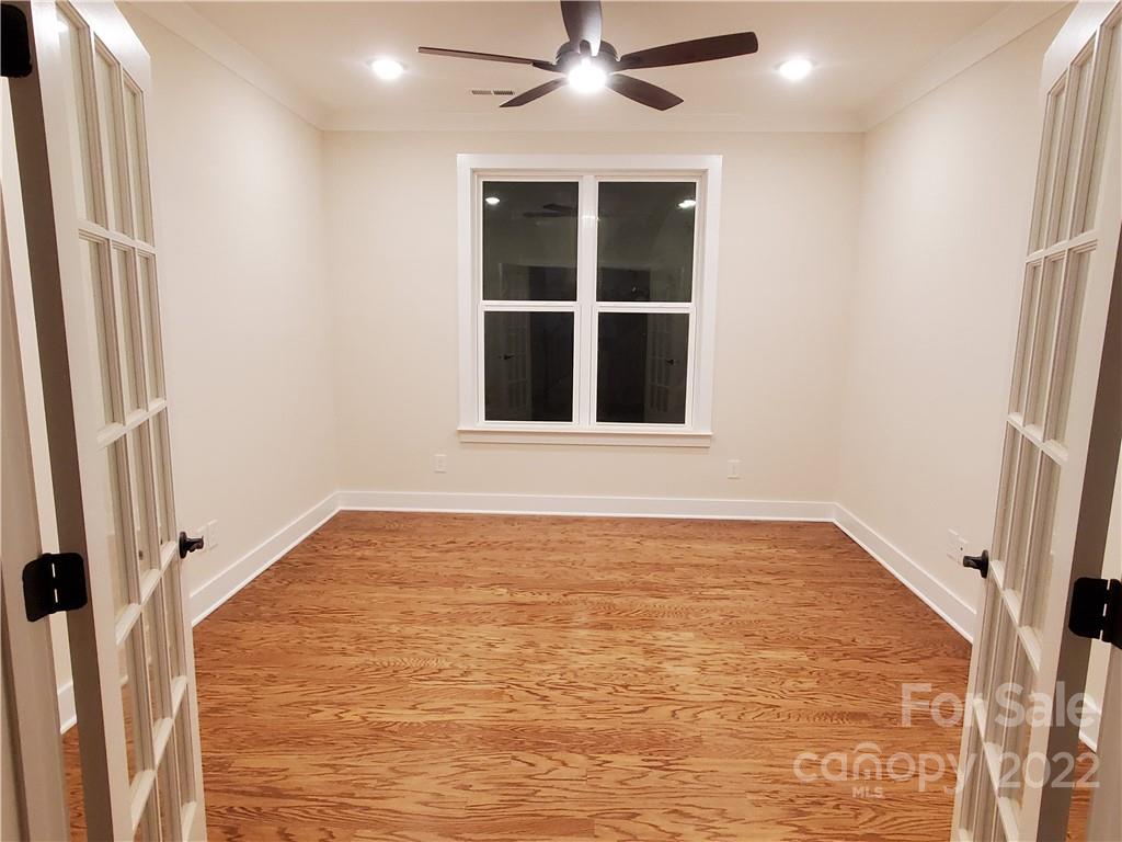 5201 Valley Stream Road Charlotte, NC 28209 - Photo 10 of 17 a view of an empty room with a window and a kitchen view