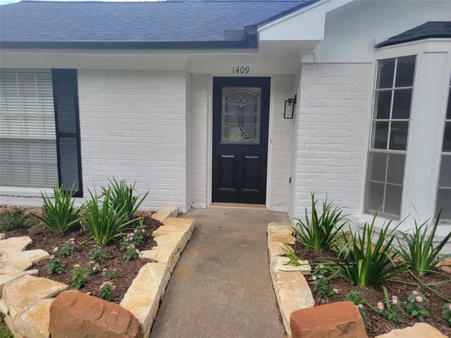 a potted plant in front of a house