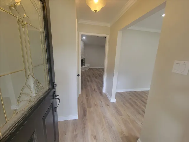 a view of hallway with wooden floor
