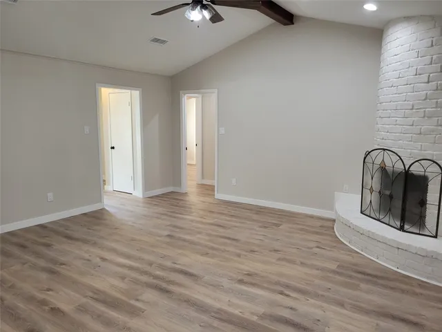 a view of a livingroom with wooden floor and chandelier