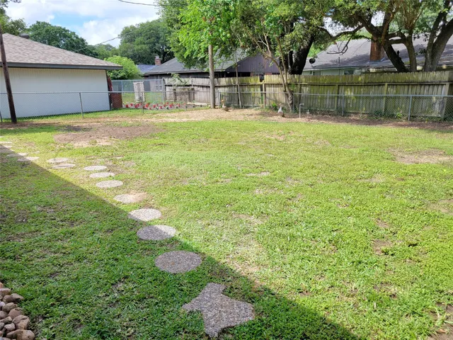 a view of a house with a yard and sitting area